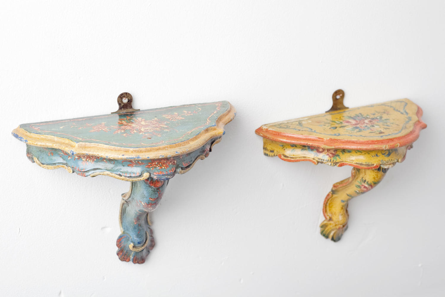 A pair of French hand-painted wall bracket shelves
